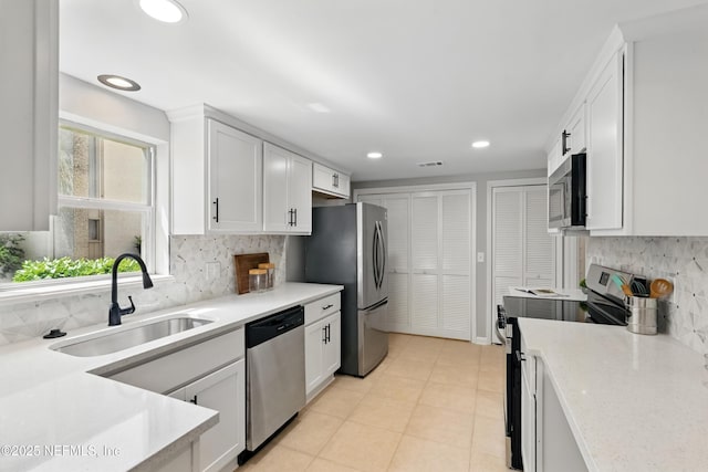 10136 Leisure Ln N Unit 26, Jacksonville, FL 32256 - kitchen featuring appliances with stainless steel finishes, a sink, light countertops, white cabinetry, and recessed lighting