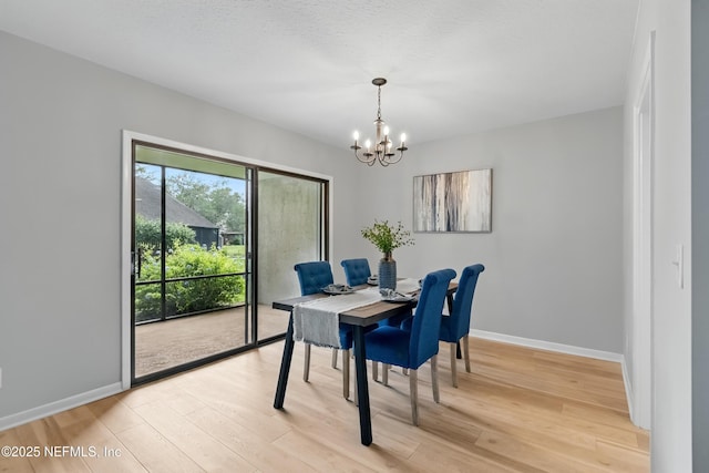 10136 Leisure Ln N Unit 26, Jacksonville, FL 32256 - dining space featuring a chandelier, light wood-style floors, and baseboards