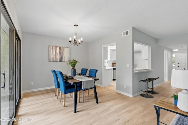 10136 Leisure Ln N Unit 26, Jacksonville, FL 32256 - dining space featuring a chandelier, light wood-type flooring, and baseboards