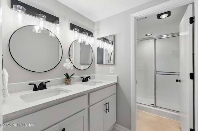 10136 Leisure Ln N Unit 26, Jacksonville, FL 32256 - bathroom with double vanity, a stall shower, tile patterned floors, and recessed lighting