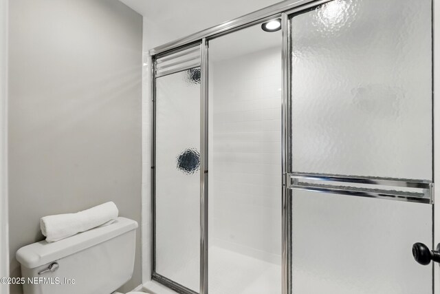 10136 Leisure Ln N Unit 26, Jacksonville, FL 32256 - bathroom featuring toilet and an enclosed shower
