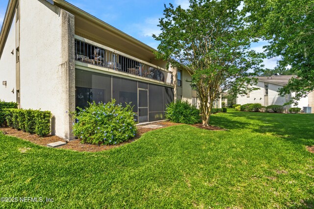 10136 Leisure Ln N Unit 26, Jacksonville, FL 32256 - back of property with a balcony, stucco siding, and a yard