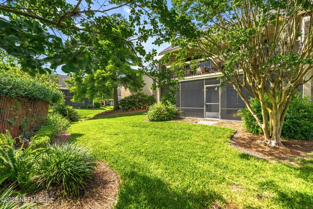 10136 Leisure Ln N Unit 26, Jacksonville, FL 32256 - view of grassy yard with a sunroom and a balcony