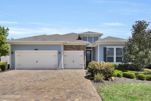 251 Dosel Ln, Saint Augustine, FL 32095 - prairie-style house featuring an attached garage, roof with shingles, and decorative driveway