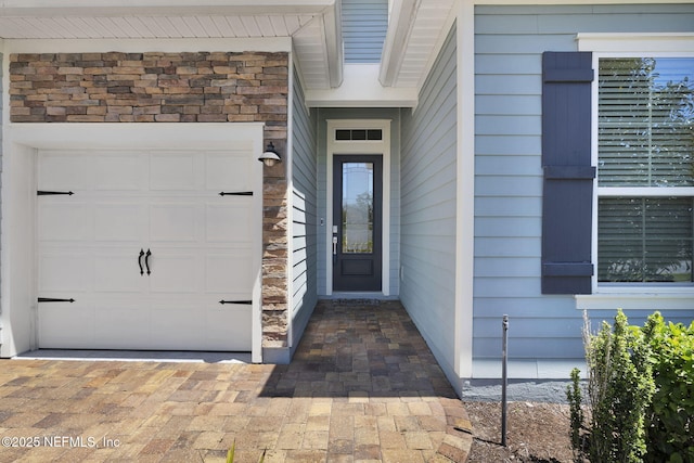 251 Dosel Ln, Saint Augustine, FL 32095 - view of exterior entry featuring stone siding and a garage