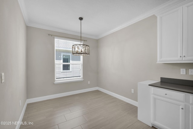 251 Dosel Ln, Saint Augustine, FL 32095 - unfurnished dining area featuring light wood-type flooring, ornamental molding, baseboards, and a notable chandelier