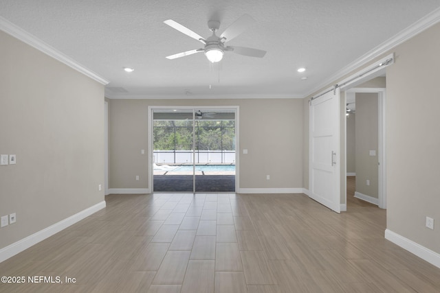 251 Dosel Ln, Saint Augustine, FL 32095 - unfurnished room with a barn door, a ceiling fan, and crown molding