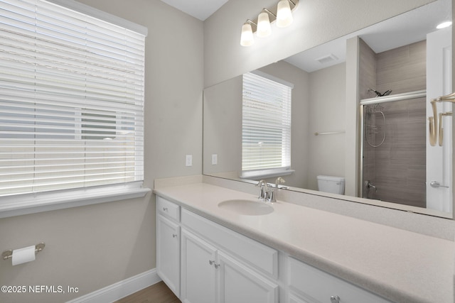 251 Dosel Ln, Saint Augustine, FL 32095 - bathroom with vanity, baseboards, a tile shower, toilet, and visible vents