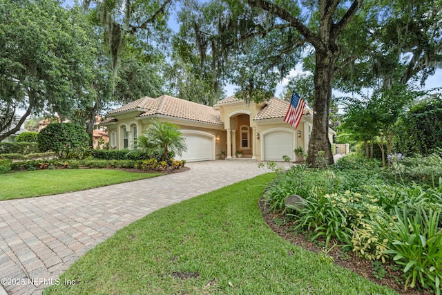 101 Dahlia Ct, Ponte Vedra Beach, FL 32082 - mediterranean / spanish house featuring a garage, stucco siding, a tiled roof, a front yard, and decorative driveway