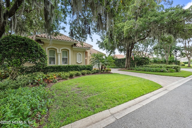 101 Dahlia Ct, Ponte Vedra Beach, FL 32082 - view of front facade with stucco siding, a tile roof, and a front yard