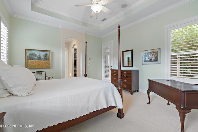 101 Dahlia Ct, Ponte Vedra Beach, FL 32082 - bedroom featuring arched walkways, carpet flooring, multiple windows, ornamental molding, and a tray ceiling