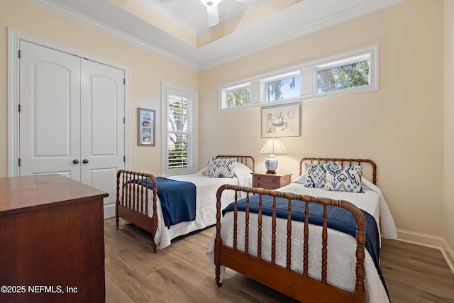 101 Dahlia Ct, Ponte Vedra Beach, FL 32082 - bedroom featuring wood finished floors, a closet, ornamental molding, and a tray ceiling