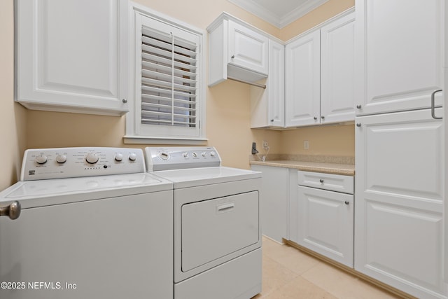101 Dahlia Ct, Ponte Vedra Beach, FL 32082 - washroom featuring washing machine and clothes dryer, ornamental molding, cabinet space, and light tile patterned floors