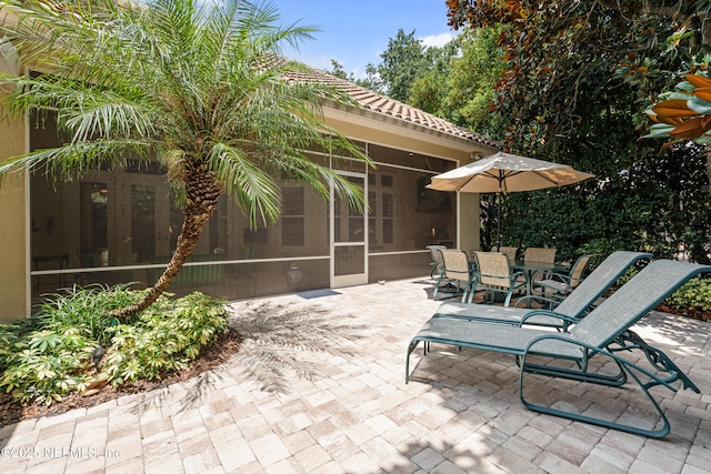 101 Dahlia Ct, Ponte Vedra Beach, FL 32082 - view of patio with a sunroom and outdoor dining area