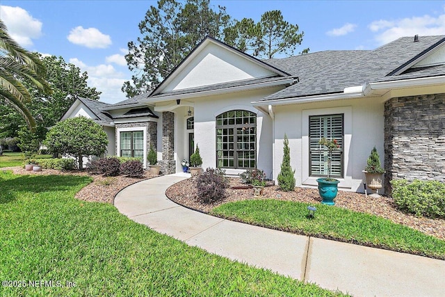 3241 Sequoyah Cir, Saint Johns, FL 32259 - view of front of house featuring a shingled roof, a front lawn, stucco siding, and stone siding