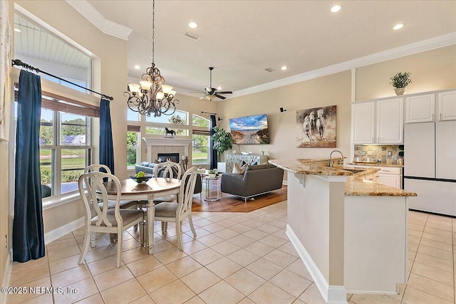 3241 Sequoyah Cir, Saint Johns, FL 32259 - kitchen with a sink, freestanding refrigerator, recessed lighting, light tile patterned floors, and ornamental molding
