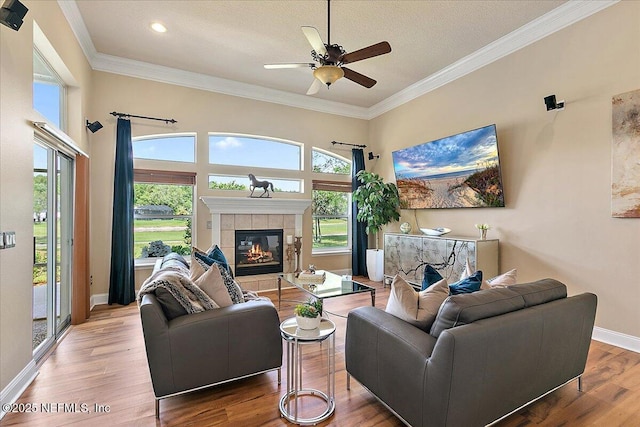 3241 Sequoyah Cir, Saint Johns, FL 32259 - living area with crown molding, a ceiling fan, baseboards, wood finished floors, and a tile fireplace