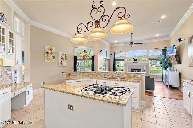 3241 Sequoyah Cir, Saint Johns, FL 32259 - kitchen with a kitchen island with sink, a sink, light tile patterned floors, ceiling fan with notable chandelier, and white appliances