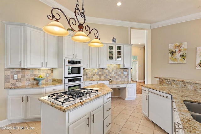 3241 Sequoyah Cir, Saint Johns, FL 32259 - kitchen featuring white appliances, white cabinetry, light tile patterned floors, backsplash, and ornamental molding