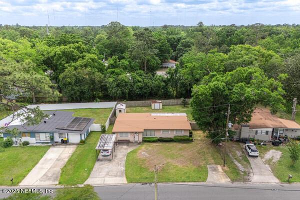 birds eye view of property with a wooded view