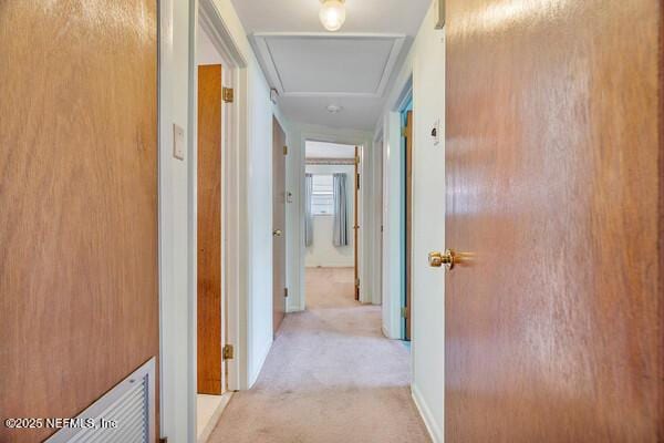 hallway with light colored carpet