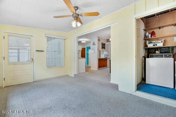 carpeted empty room with baseboards and ceiling fan