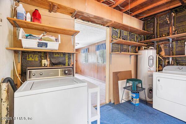 clothes washing area featuring carpet, washing machine and clothes dryer, laundry area, and electric water heater