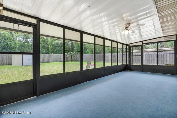 unfurnished sunroom with a healthy amount of sunlight and a ceiling fan