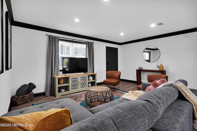 living room with crown molding, baseboards, and wood finished floors
