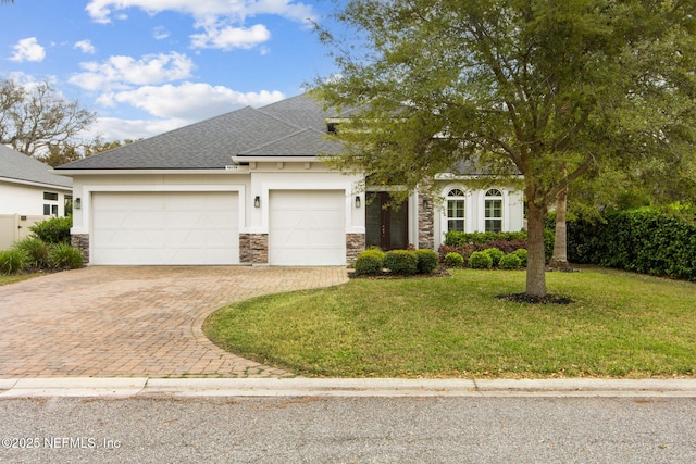 view of front of property with a front lawn, stone siding, a garage, stucco siding, and decorative driveway