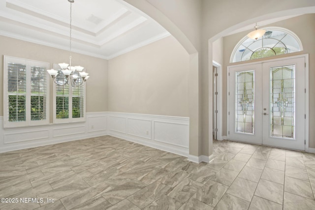 foyer featuring french doors, a tray ceiling, visible vents, a notable chandelier, and marble finish floor