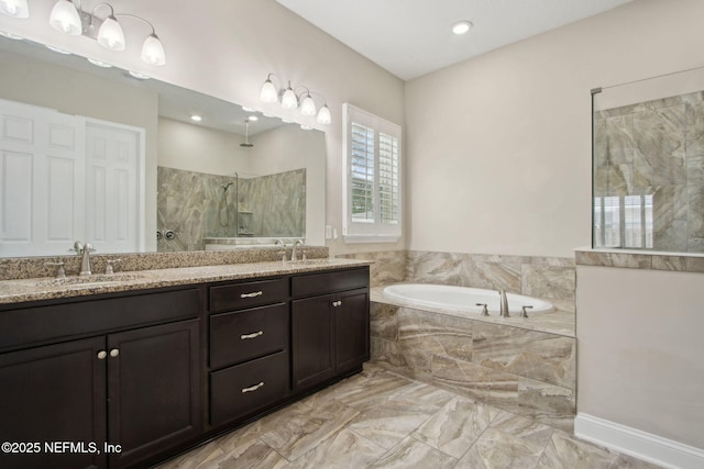 full bathroom featuring a bath, walk in shower, marble finish floor, and a sink