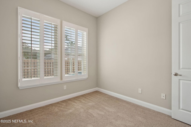 empty room with carpet floors and baseboards