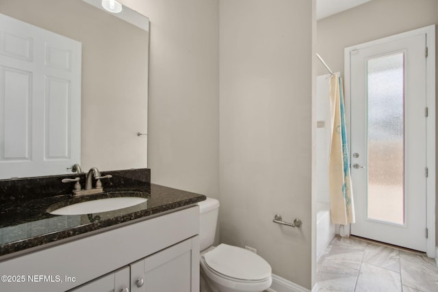 bathroom with vanity, shower / tub combo with curtain, marble finish floor, baseboards, and toilet