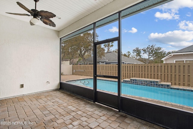 view of pool featuring fence, a hot tub, a patio, and ceiling fan