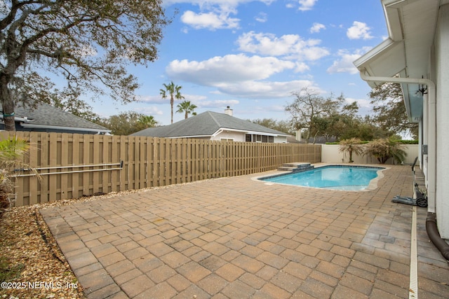view of pool with a fenced in pool, a fenced backyard, and a patio