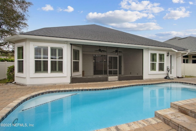 back of property featuring a fenced in pool, roof with shingles, fence, a patio area, and ceiling fan