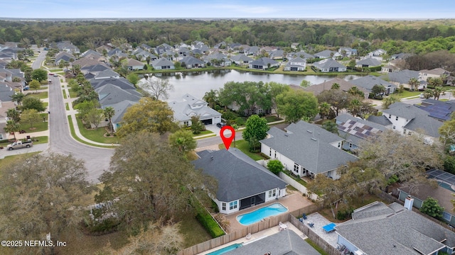 drone / aerial view featuring a residential view and a water view