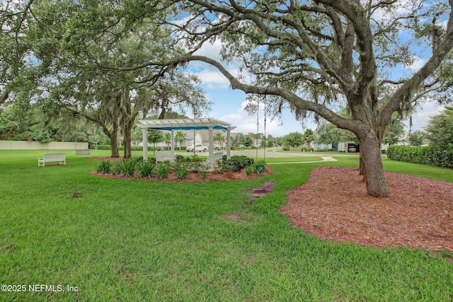 view of home's community featuring a pergola and a yard