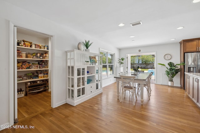dining area featuring visible vents, light wood finished floors, and recessed lighting