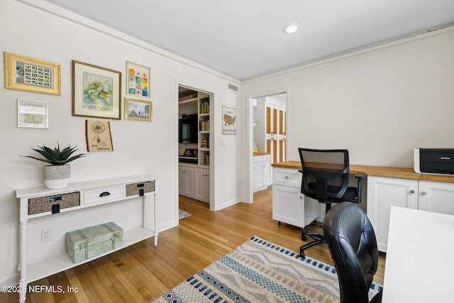 office with recessed lighting and light wood-style floors