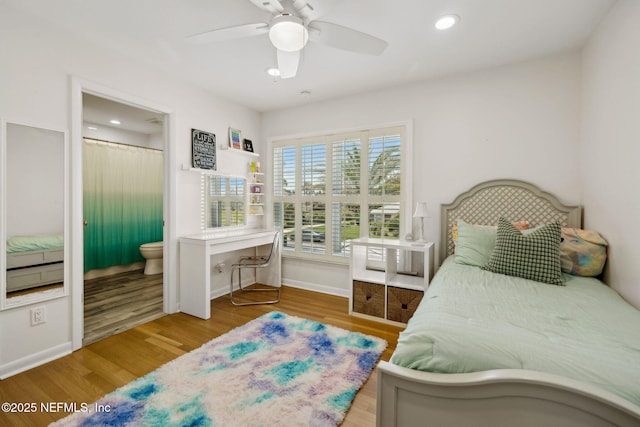 bedroom with recessed lighting, ensuite bath, wood finished floors, and baseboards