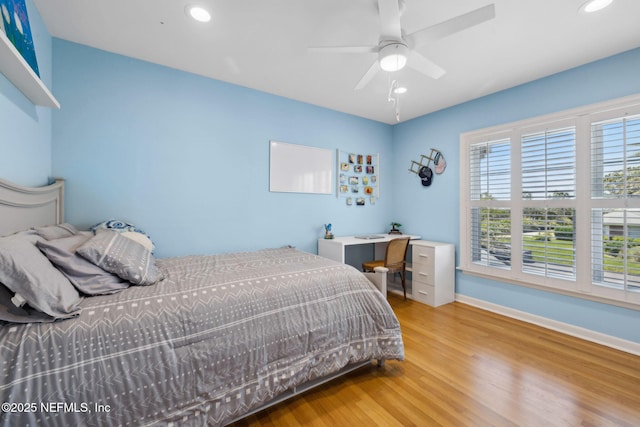 bedroom featuring wood finished floors, recessed lighting, and baseboards