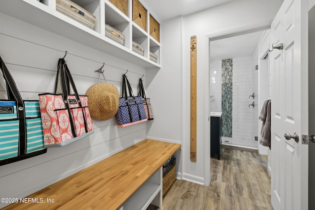 mudroom featuring wood finished floors and baseboards