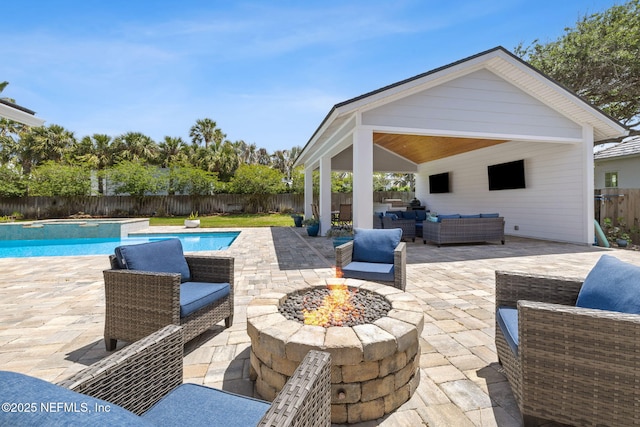 view of patio with an outdoor living space with a fire pit, a fenced in pool, and a fenced backyard