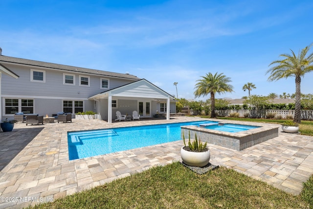 view of swimming pool with a patio, an outdoor living space, french doors, fence private yard, and a pool with connected hot tub