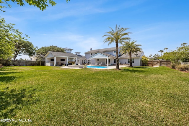view of yard featuring a patio, a fenced in pool, and a fenced backyard