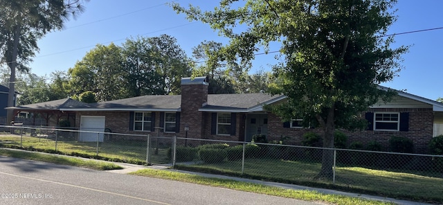 single story home with a fenced front yard, brick siding, and a garage