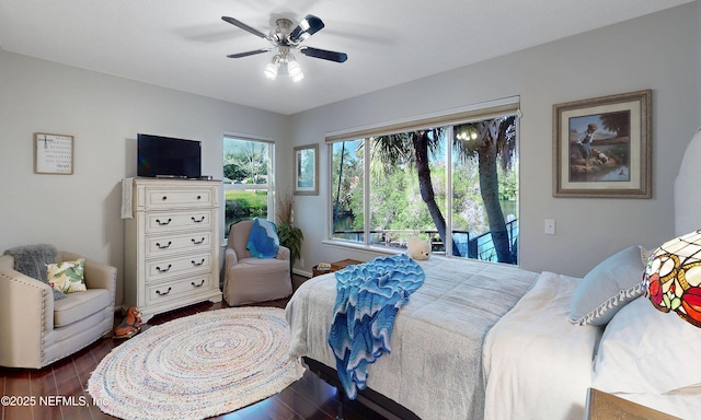 bedroom with wood finished floors, a ceiling fan, and access to outside
