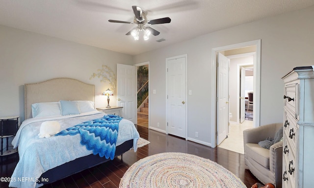 bedroom featuring a ceiling fan, wood finished floors, and visible vents